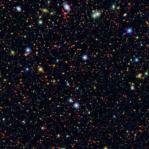 Galaxies in infrared (red) and visible light (blue and green), in a survey showing that some early galaxies were much bigger babies than expected. [Credit: NASA/JPL-Caltech]